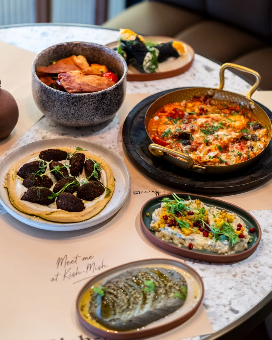A table crowded with shared meze plates, seen from above