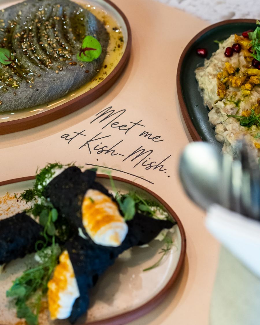 Meze plates being shared on a Kish-Mish placemat