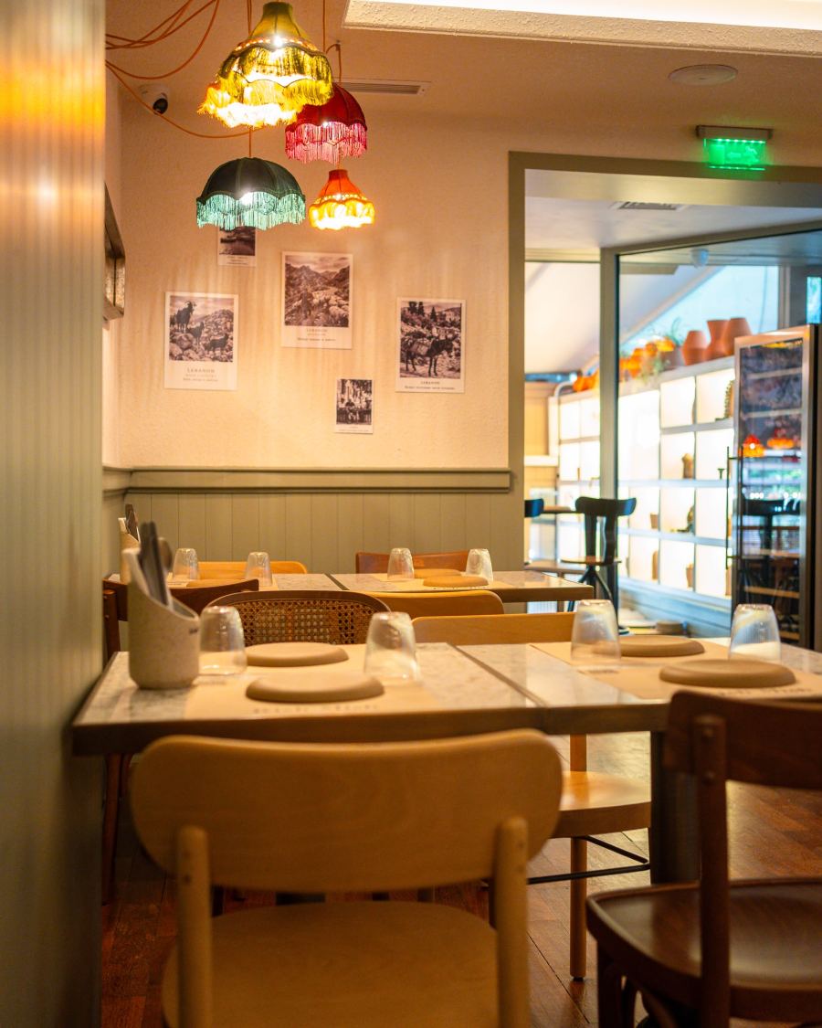 A quiet corner with vintage photos and fringed lampshades