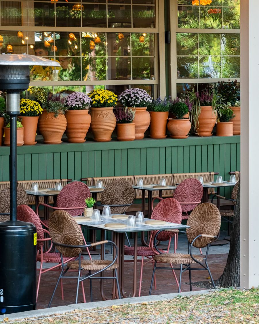 Wicker chairs and set tables on the garden terrace